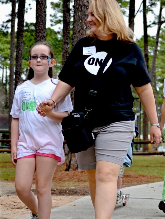 Mother and daughter walk together and support the cause hand-in-hand.