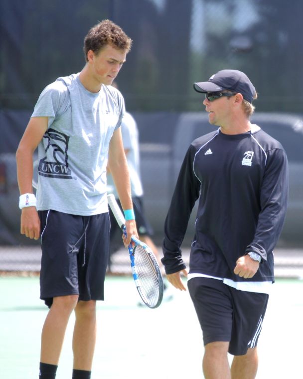 Coach+Mait+DuBois+offers+a+few+pointers+to+a+member+of+the+mens+tennis+team+at+the+match+against+Old+Dominion.