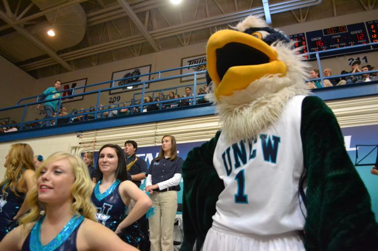 Sammy the Seahawk watches from the sidelines as the UNCW mens basketball team pushes past the Northeastern Huskies. Sammy not only serves as a symbol of UNCW, but he also serves as the physical embodyment of school spirit and the campus and community coming together to cheer on our Boys in Teal.