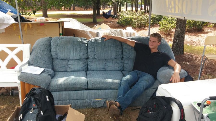 ATO member and UNCW senior Robert Markus sits on a couch that several members took turns sleeping on during the fundraiser. 