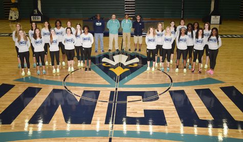 Team photo of the women's track and field team along with their coaches.