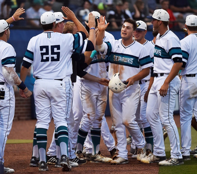 Gavin Stupienski (above) slaps high-fives with his teammates after one of two home runs hit by the senior Wednesday night.