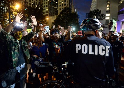 Protestors confront bicycle officers along Trade Street in Charlotte, N.C., on Wednesday, Sept. 21, 2016. The protestors were rallying against the fatal shooting of Keith Lamont Scott by police on Tuesday evening in the University City area. (Jeff Siner/The Charlotte Observer/TNS)