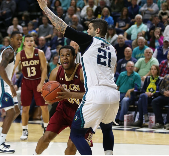 Marcus Bryan (21) defends against an Elon ball handler in last Mondays 79-63 CAA win.