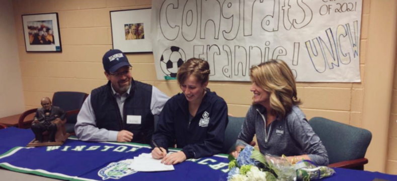 Francine Phillips, one of 12 recruits to commit to UNCW womens soccer on Feb. 1, signs her National Letter of Intent.