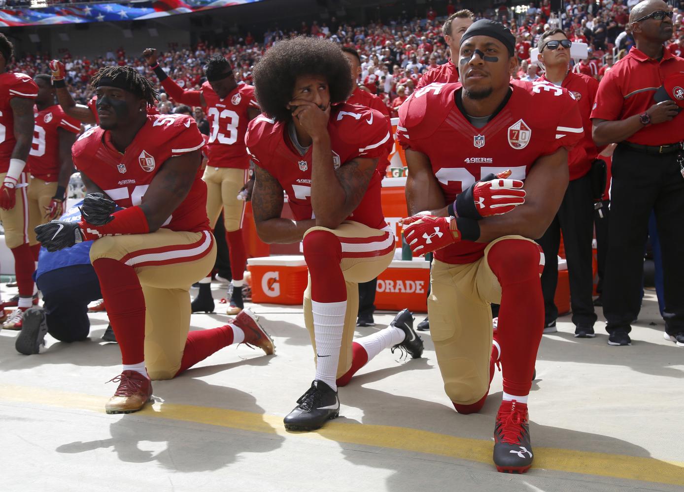 From left, San Francisco 49ers' Eli Harold (58), quarterback Colin Kaepernick (7) and Eric Reid (35) kneel during the national anthem before their NFL game against the Dallas Cowboys on Sunday, Oct. 2, 2016 in Santa Clara, Calif. (Nhat V. Meyer/Bay Area News Group/Tribune News Service)