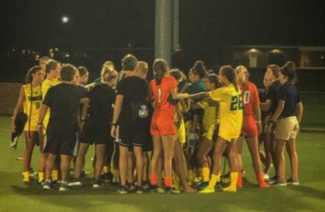 Members of the UNCW and Virginia women's soccer teams gather for a postgame huddle on Friday, Aug. 18.