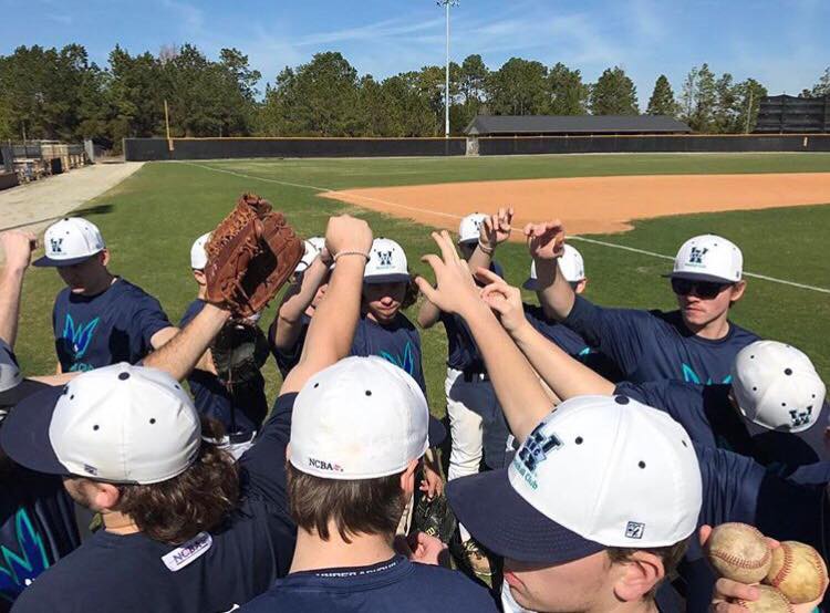 UNC Wilmingtons club baseball team gets ready to break a huddle during practice. 