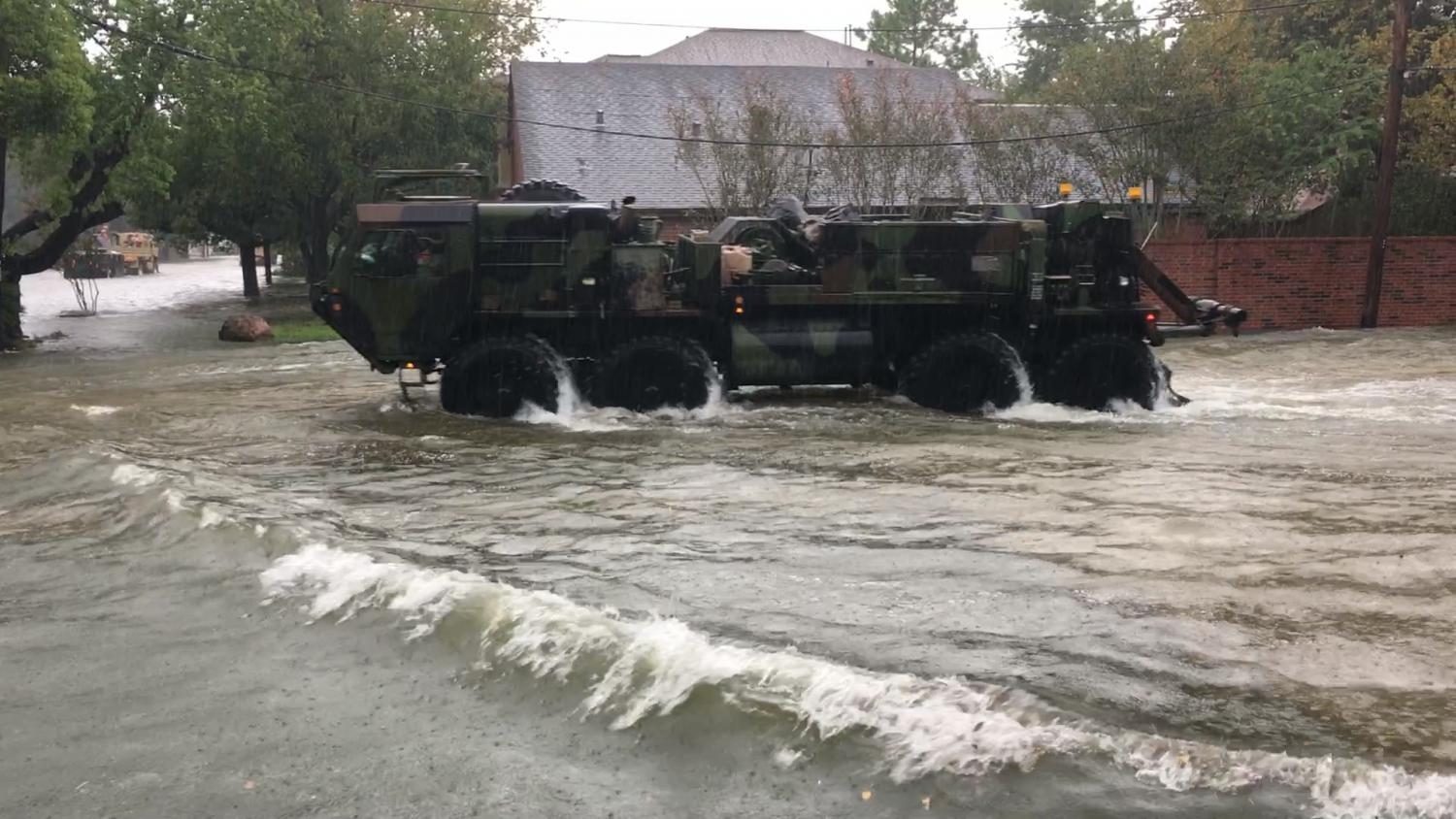 Armored vehicles moving down the streets of Houston on their way to aid civilians caught in the storm. 