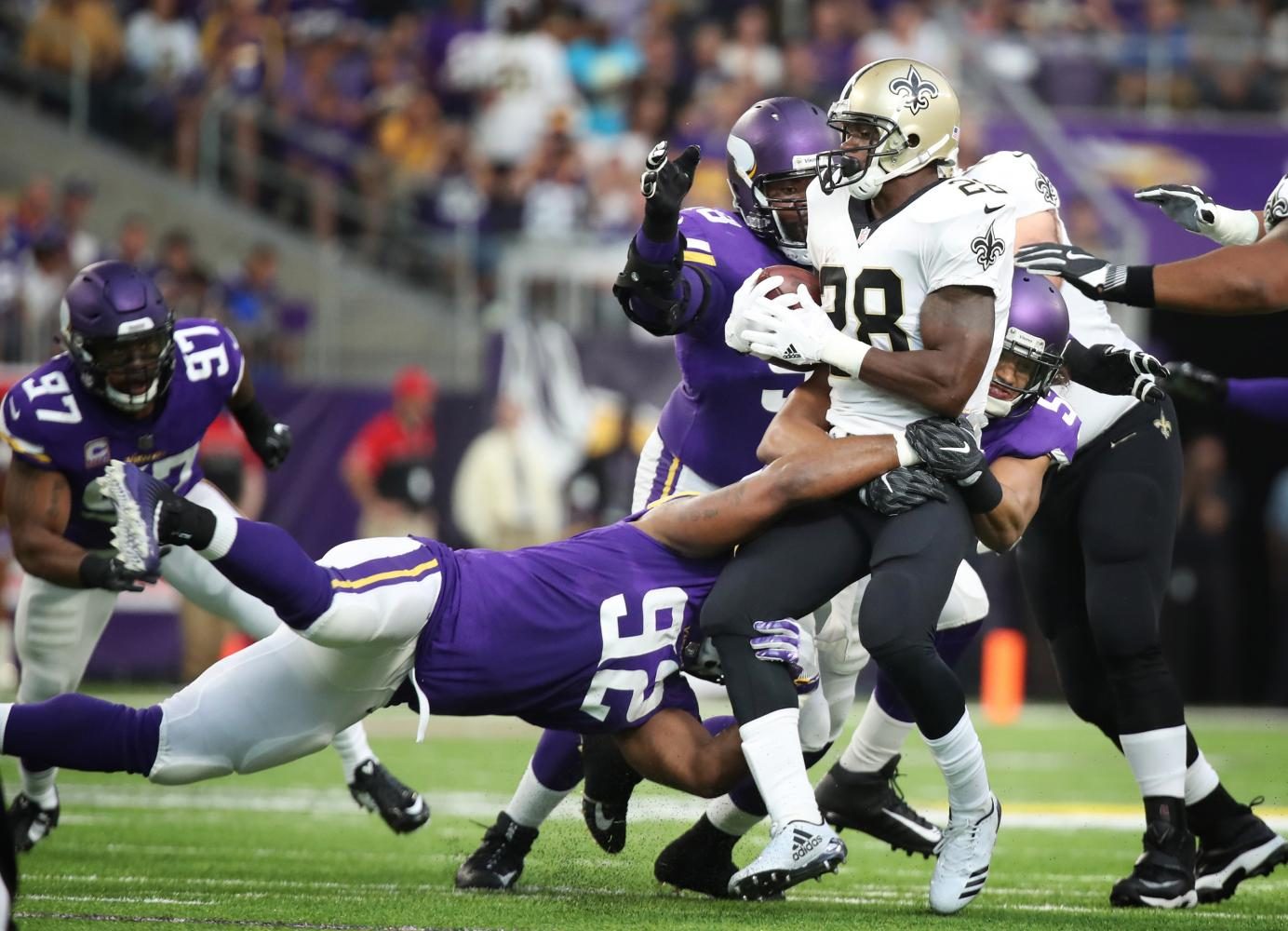 New Orleans Saints running back Adrian Peterson (28) is stopped for no gain by Minnesota Vikings defensive tackle Tom Johnson (92), and middle linebacker Eric Kendricks (54) in the first quarter Monday night, Sept. 11, 2017 at U.S. Bank Stadium in Minneapolis, Minn. The Vikings won, 29-19.