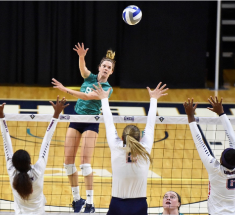 Maddy Kline (9) returns a serve in UNCW's 3-1 win over Liberty on Friday, Sept. 15, 2017.
