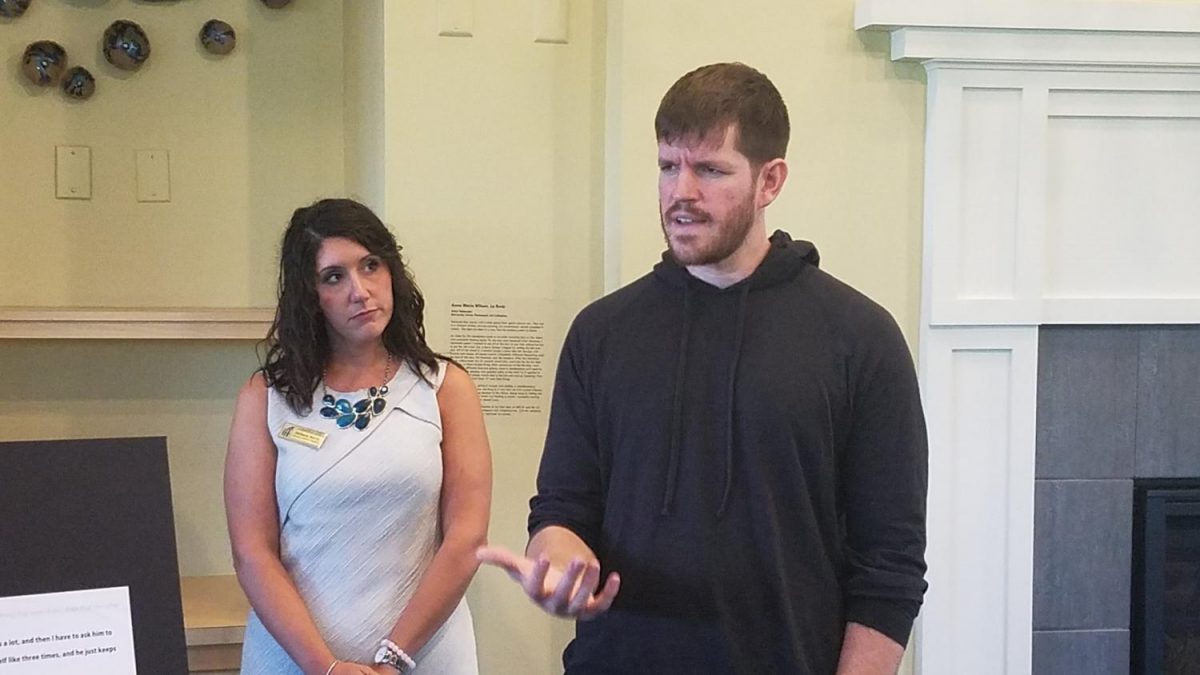 Director of Campus Life Arts and Programs Stefanie Norris, left, looks on as Brandon Stanton, creator of Humans of New York, addresses those gathered at a reception prior to his lecture in UNC Wilmingtons Burney Center on Tuesday, Sept. 27.