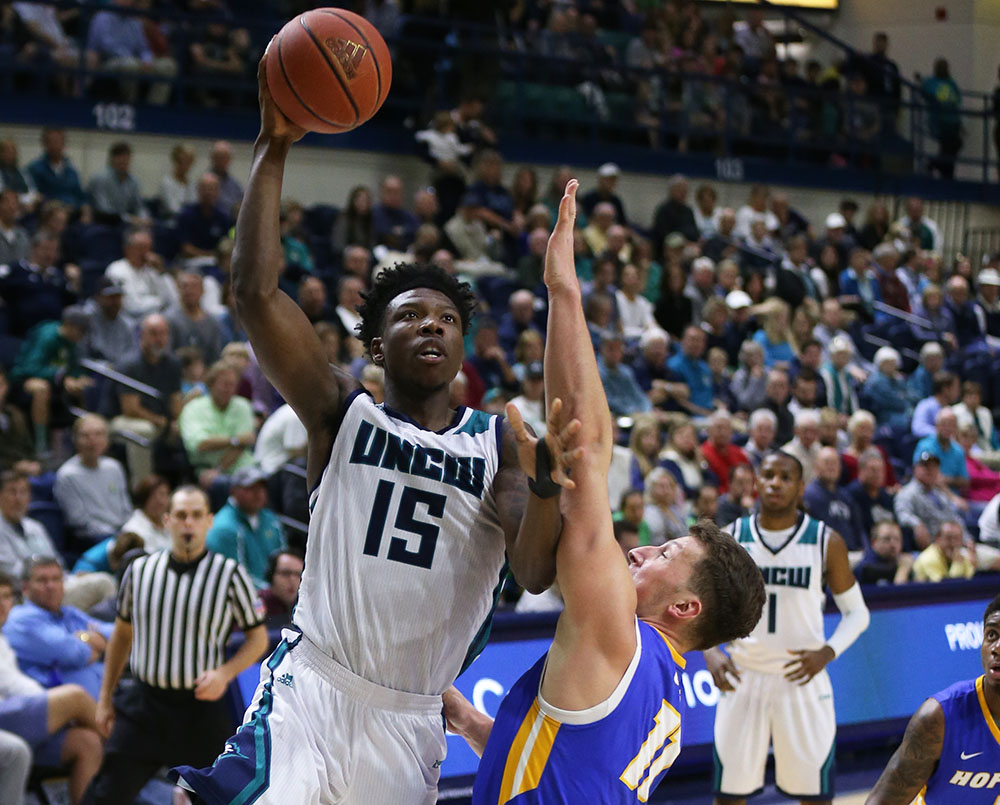 Devontae Cacok (15) goes up for a basket in a home game vs. Delaware during UNCW's 2017 basketball season.
