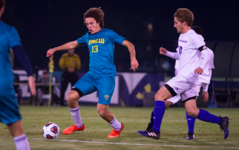 Midfielder Kalvin Kromer (13) dribbles the ball in UNC Wilmington's 1-0 overtime win vs. Presbyterian on Thursday.