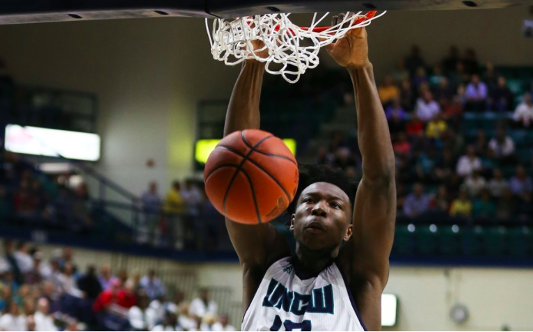 Devontae+Cacok+slams+a+ball+through+the+hoop+in+UNCWs+88-84+win+over+Campbell+on+Saturday.