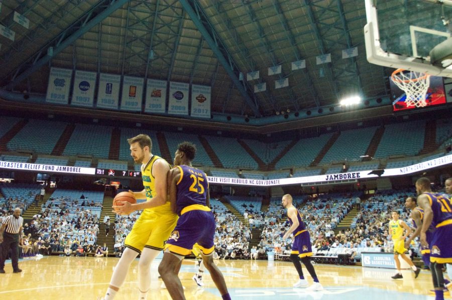 UNC Wilmingtons Trey Kalina posts up an ECU defender in the NC Disaster Relief Jamboree on Sunday, Nov. 5, 2017. 