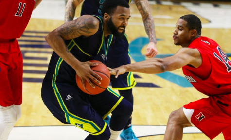 UNCW's Jordon Talley fights through Northeastern's defense in Saturday's 81-77 overtime loss.