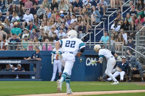 No. 7 Jackson Meadows and No. 22 Noah Bridges run to first base and home respectively following a pop-fly hit to center field by Meadows.