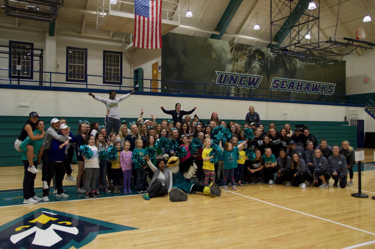 UNCW women's sports teams and young female athletes gathered for a group picture at Friday's National Girls and Women in Sports Day event.