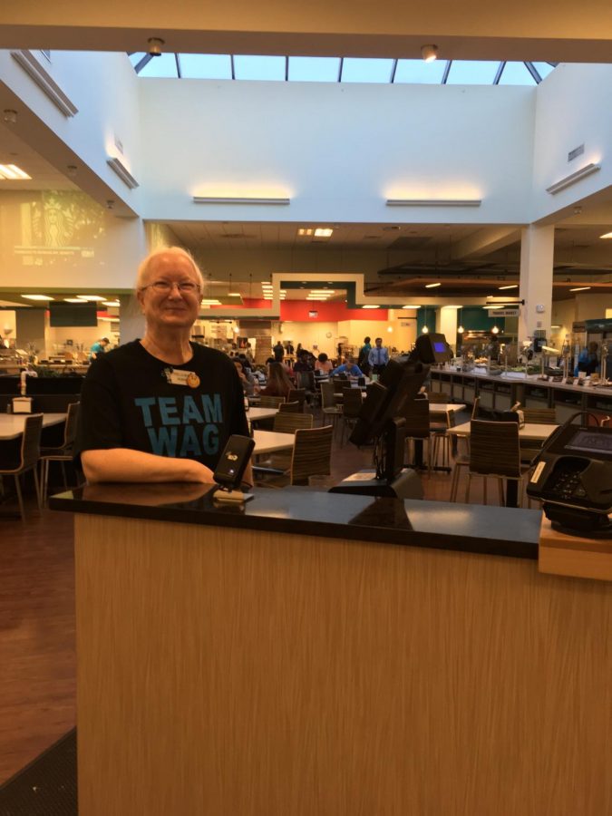 Robin, front-end cashier at Wag Hall, smiles for her final photo at UNCW (missing: her purple coat).