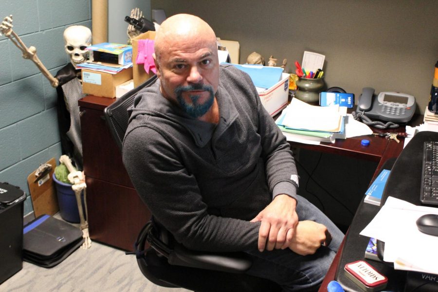 Dr. Jorge Figueroa, pictured, sits in his office in Trask Coliseum sporting his teal goatee. The goatee, among other things, has earned him the nickname That guy.