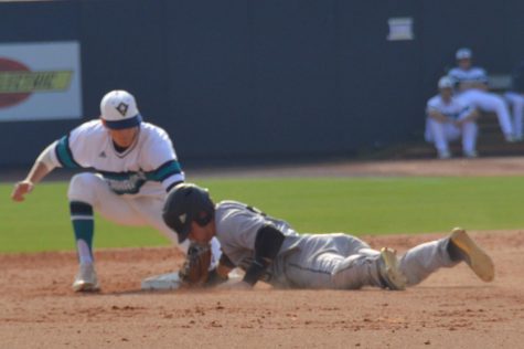 Second baseman no. 4 Doug Angeli attempts to tag out a Wofford runner