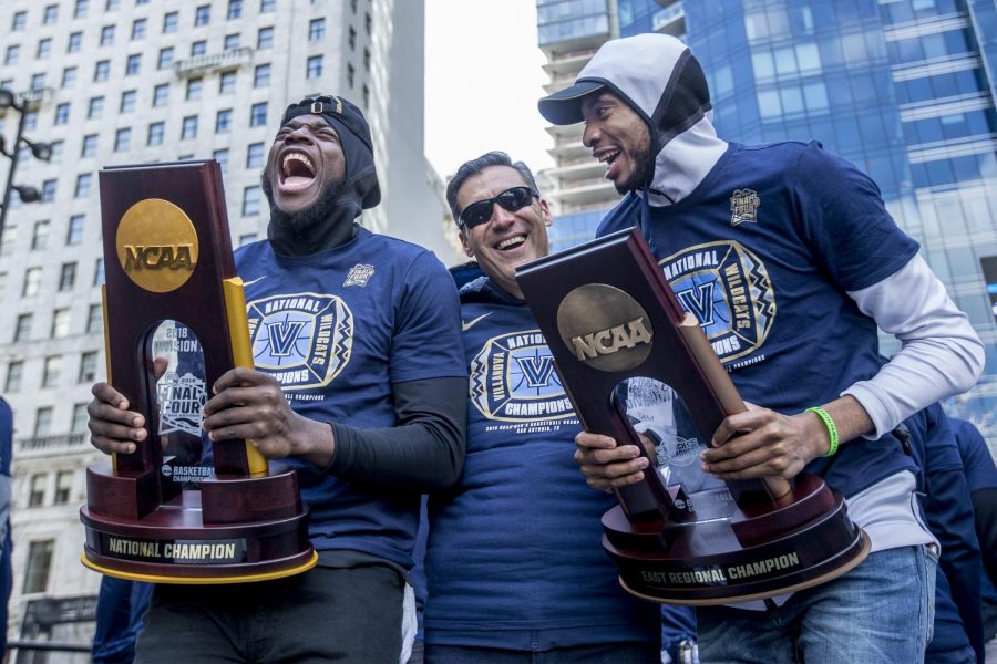 Villanovas Eric Paschall, left, head coach Jay Wright, center, and Mikal Bridges, right, celebrate as they show off the NCAA Tournament and Eastern Regional Trophies to the massive crowd gathered for the NCCA Champions Parade at Dilworth Park in Philadelphia on Thursday April 5, 2018.