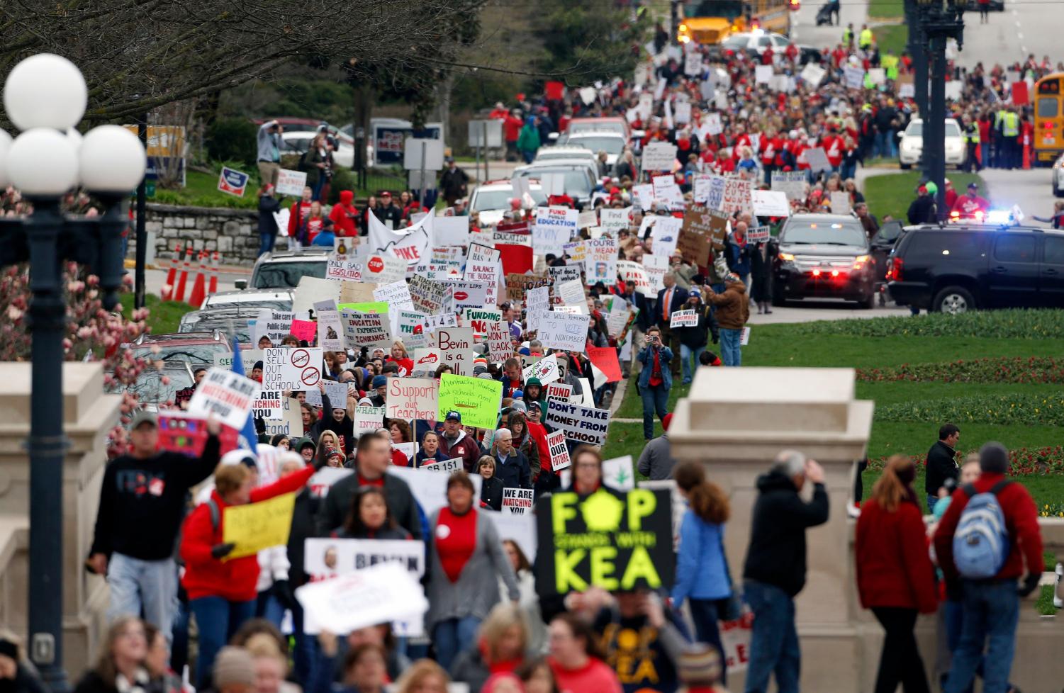 Thousands of Kentucky school teachers marched Monday, April 2, 2018 from the Kentucky Education Association's headquarters to the State Capitol in Frankfort, Ky. to protest legislative changes to their pensions and education cuts. Public schools in all 120 Kentucky counties were closed Monday, either to join in the protest or because of spring break.