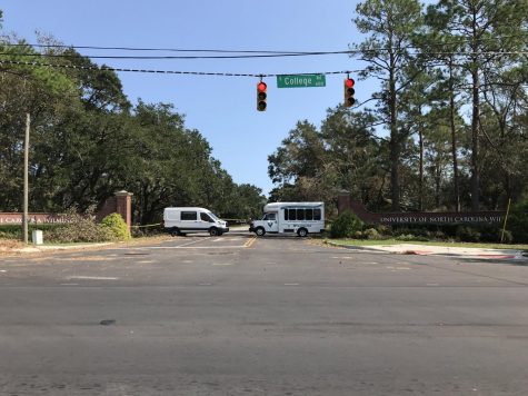 UNCW vehicles blocking the front of campus which is still closed.
