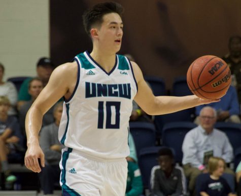 Kai Toews (10) dribbles up court during UNCW's Tuesday night game v.s. UNC Greensboro