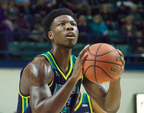 Devontae Cacok (15) attempts a free throw during UNCW's matchup against East Carolina on Nov. 27, 2018.
