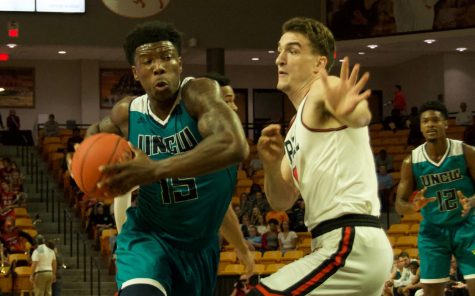 Devontae Cacok (15) drives through the lane for a layup during UNCW's season opener against Campbell.