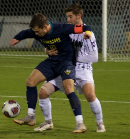 Phillip Goodrum (10) squares up with a defender during UNCW's NCAA Tournament first round match against Furman