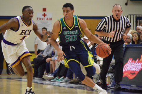 Jaylen Sims (30) dribbles up court during UNCW's 95-86 win against East Carolina on Nov. 27, 2018.