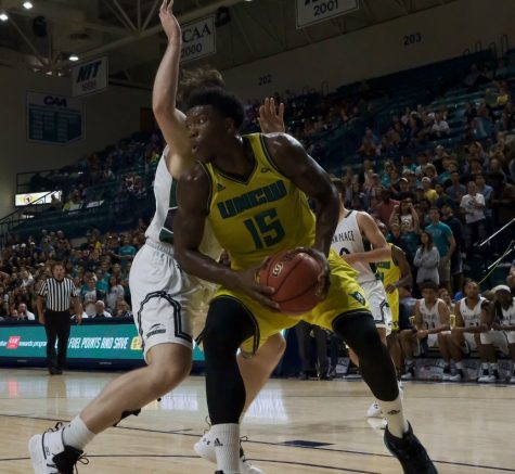 Devontae Cacok (15) bodies a defender during UNCW's exhibition against William Peace