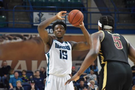 Devontae Cacok (15) looks to pass during UNCW's conference opener against College of Charleston on Dec. 29, 2018.