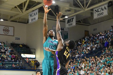 Devontae Cacok (15) hits a hook shot during UNCW's Homecoming matchup against James Madison on Feb. 2, 2019.