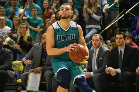 Jaylen Fornes (1) pulls up for a three-pointer during UNCW's Homecoming matchup against James Madison on Feb. 2, 2019.