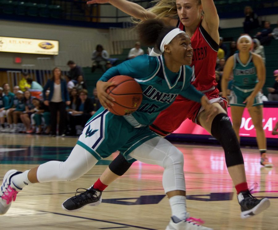 Ahyiona Vason (10) drives past a defender during UNCWs contest against Northeastern on Feb. 3, 2019.