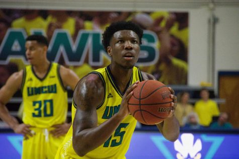 Devontae Cacok (15) attempts a free throw during UNCW's matchup with Northeastern on Feb. 14, 2019