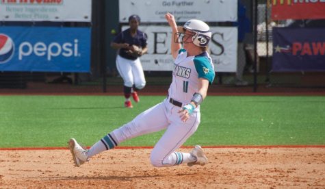 Camryn Dean (11) slides into third base during UNCW's matchup with Howard in the Fairfield Inn & Suites Seahawk Softball Bash on Feb. 15, 2019.