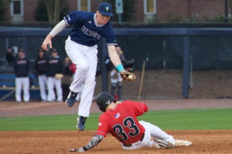 Cole Weiss (8) looks to tag out a runner to give UNCW the 5-3 win during the Seahawks' matchup with VMI on Feb. 17, 2019.