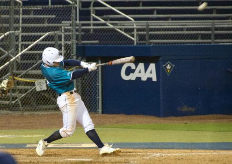 Doug Angeli (4) hits a homer during UNCW's matchup against Coastal Carolina on Feb. 19, 2019 at Brooks Field.