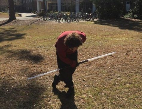 Beau Carlson, double-bladed lightsaber in hand, takes a bow outside Fisher Student Center on Feb. 6
