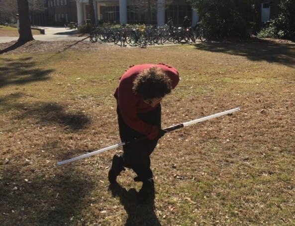 Beau Carlson, double-bladed lightsaber in hand, takes a bow outside Fisher Student Center on Feb. 6