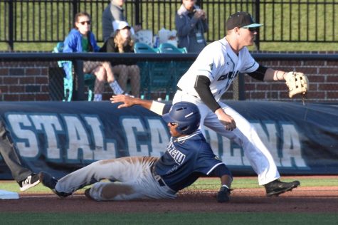 Greg Jones (2) slides into third base during UNCW's matchup against Coastal Carolina at Springs Brooks Stadium on March 27, 2019.