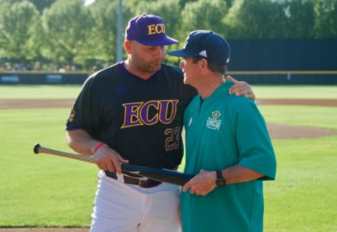 ECU coach Cliff Godwin (left) honors retiring UNCW coach Mark Scalf in a pregame ceremony at Clark-LeClair Stadium on April 23, 2019.