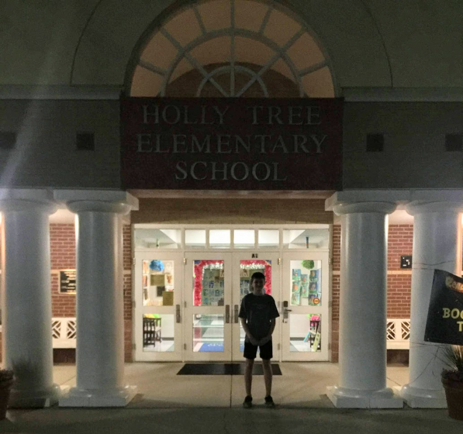 Writer Jacob Sawyer standing in front of his former primary school, Holly Tree Elementary School on April 26, 2017