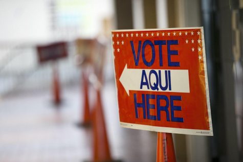 A sign points voters to an early voting location at ACC-Highland Mall.