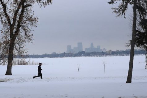 A runner endures yet another sunless day in Minnesota along Bde Maka Ska Tuesday, Jan. 28, 2020, in Minneapolis.